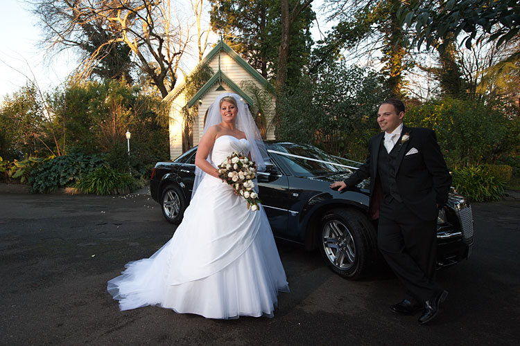 bride and groom in garden outside bram leigh wedding chapel
