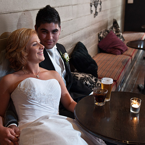 Melbourne Newlyweds enjoying a dring in a tavern-like bar setting.