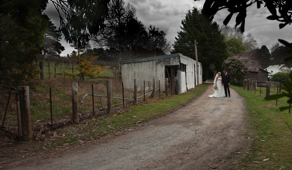 photo of wedding showing a melbourne bridal couple walking along a quiet country lane